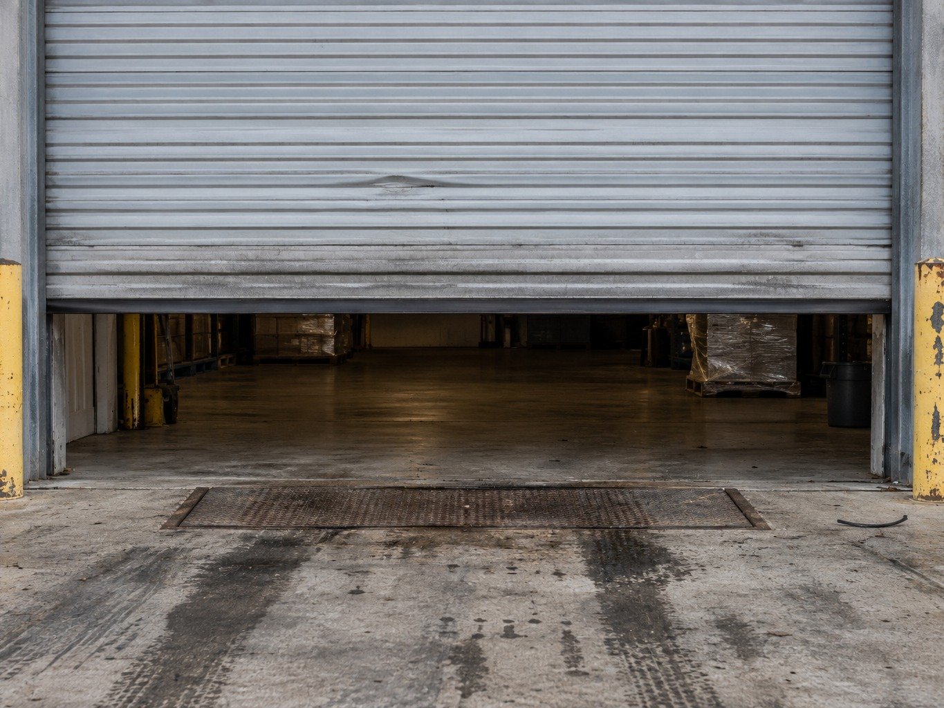 Commercial roll-up garage door being serviced
